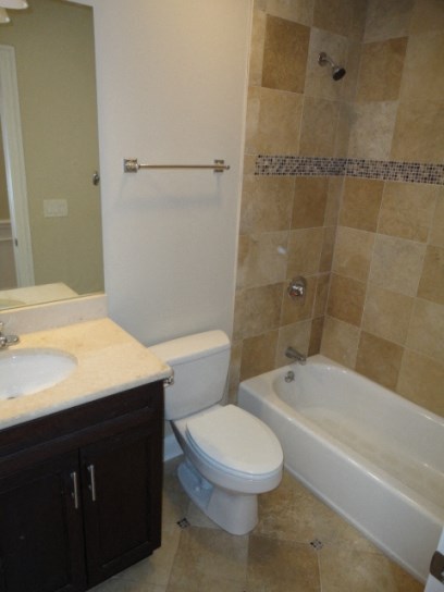 a bathroom with a toilet and a tub and a sink