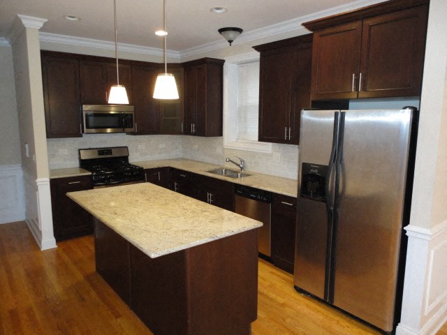 a kitchen with stainless steel appliances and a counter top