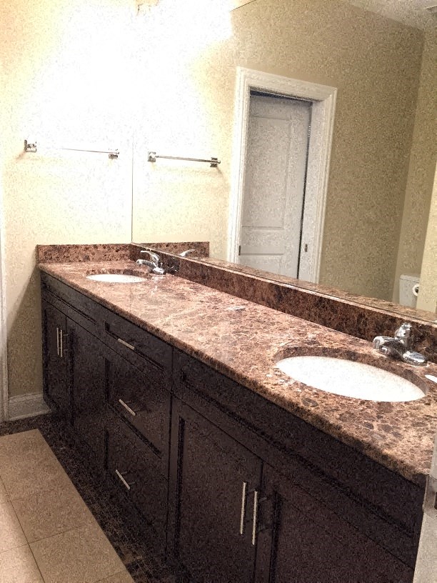 a bathroom with two sinks and a mirror