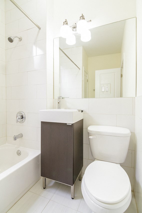 a bathroom with a toilet and a sink and a bath tub