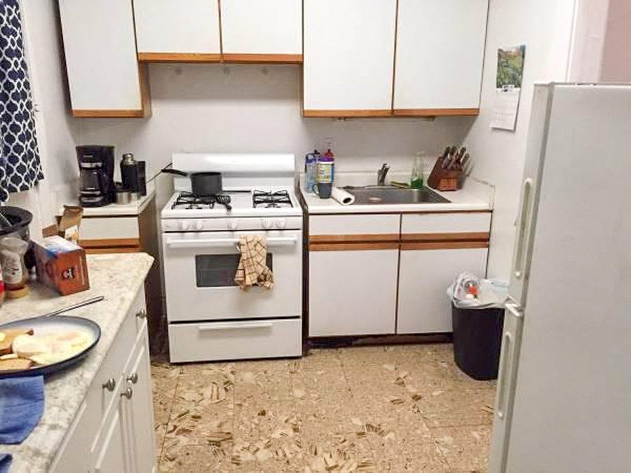 a kitchen with a stove and a sink and a refrigerator