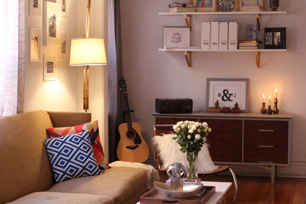 a living room with a couch and a guitar in it