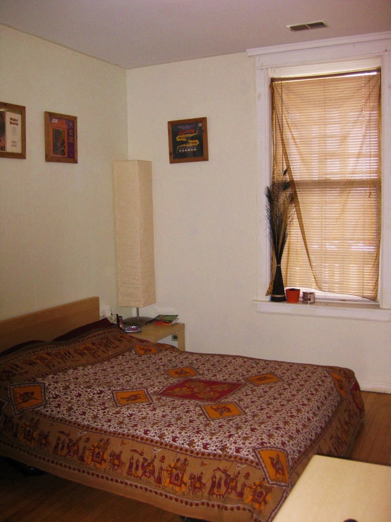 a bedroom with a bed and a window