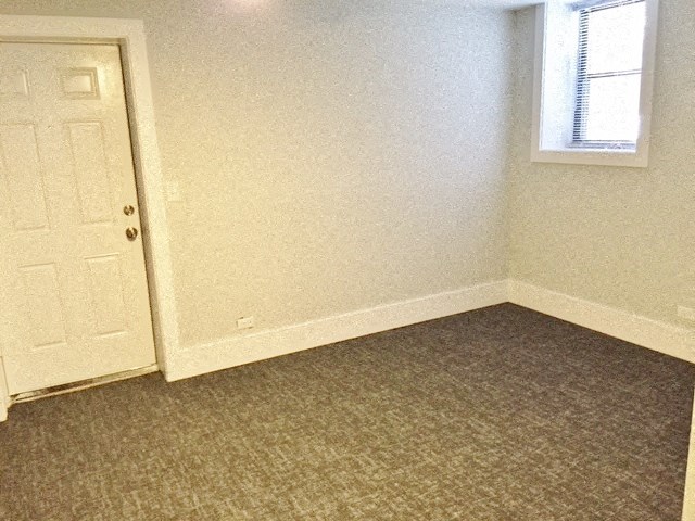 an empty room with a door and a window