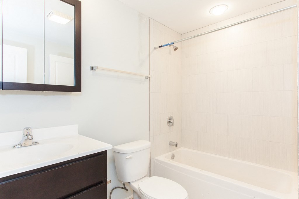 a bathroom with a sink toilet and a tub