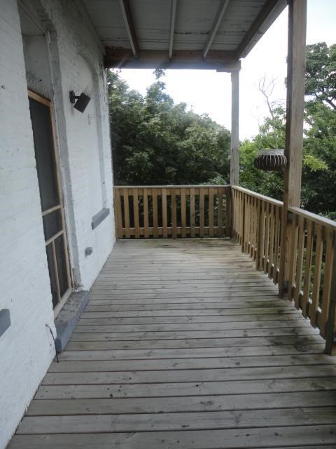 a porch with a wooden deck