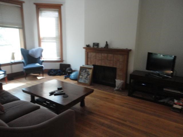 a living room with a couch a table and a television