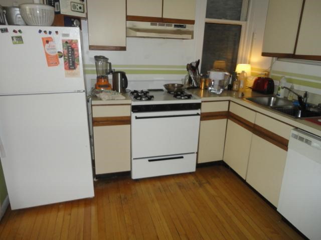 a small kitchen with a stove and a refrigerator