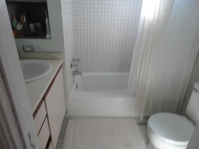 a white bathroom with a toilet and a sink
