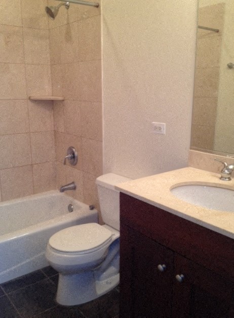 a bathroom with a toilet and a sink and a bath tub