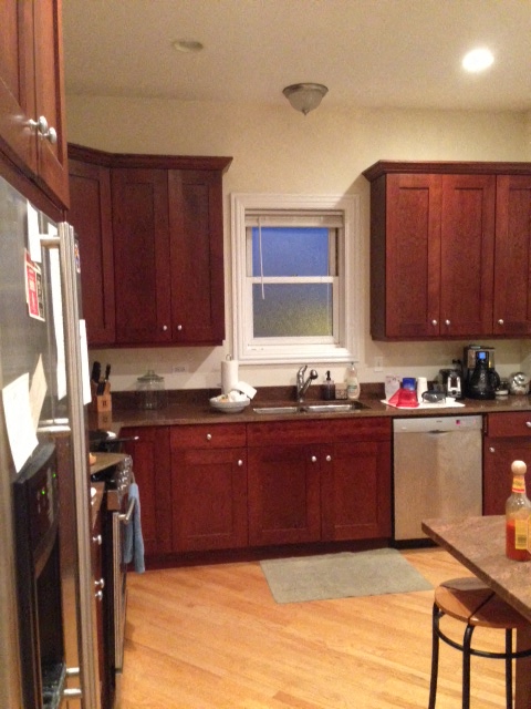 a kitchen with wooden cabinets and a window