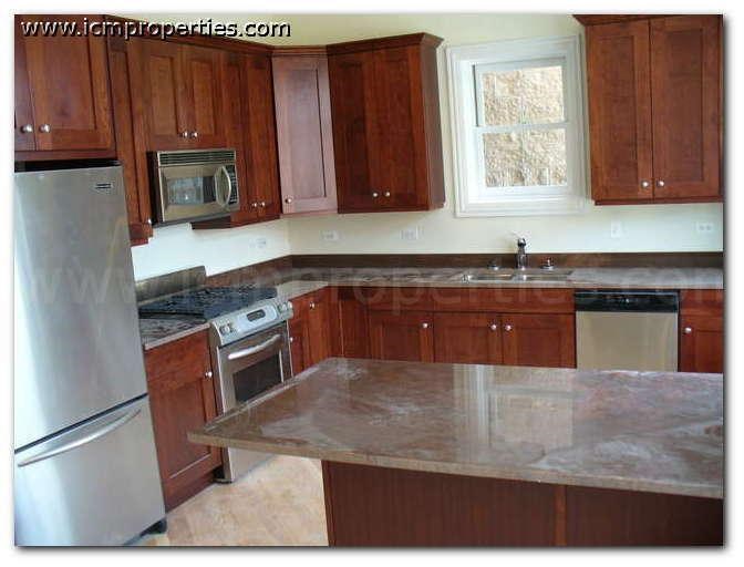 a kitchen with wooden cabinets and stainless steel appliances