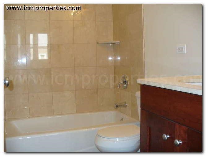 a bathroom with a toilet and a bath tub