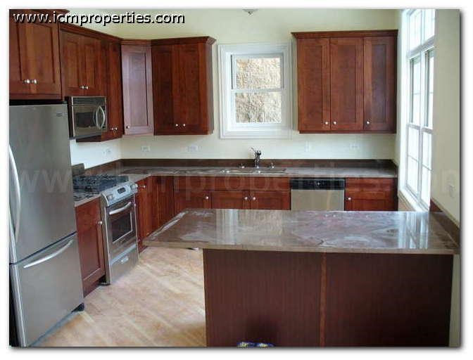 a kitchen with wooden cabinets and stainless steel appliances
