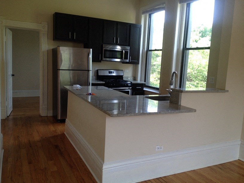 a kitchen with a counter top and a refrigerator