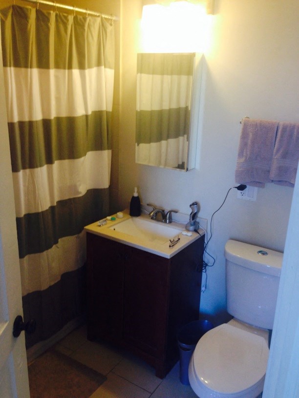 a bathroom with a toilet and a sink and a shower