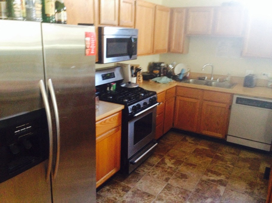 a kitchen with stainless steel appliances and wooden cabinets