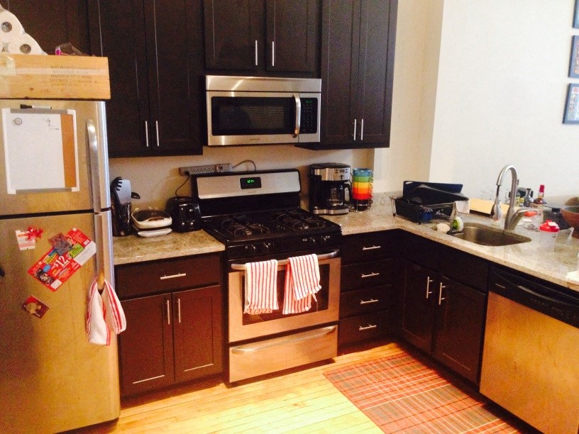 a kitchen with wooden cabinets and stainless steel appliances