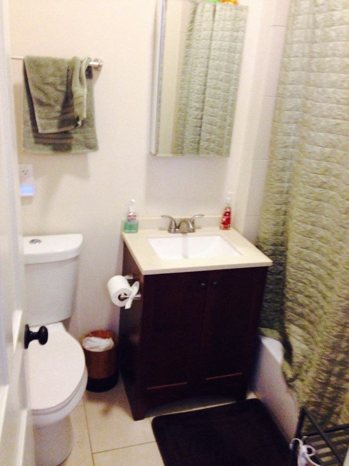 a bathroom with a sink toilet and shower curtain