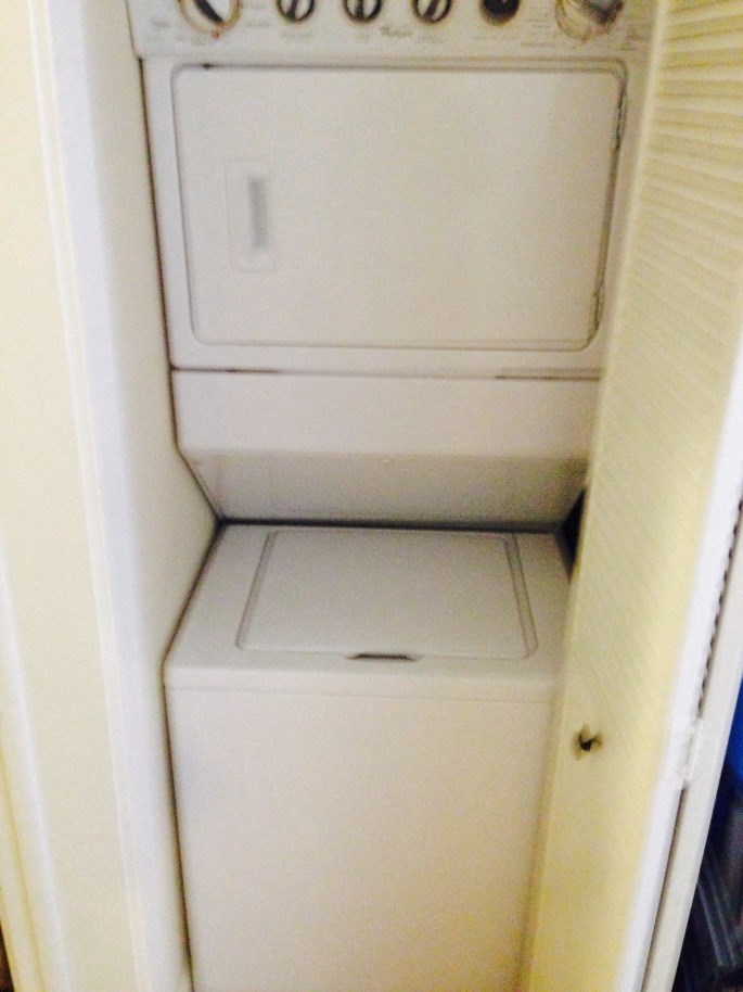 an empty white refrigerator and freezer in a room