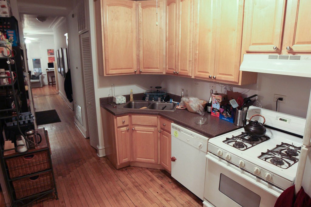 a kitchen with white appliances and wooden cabinets