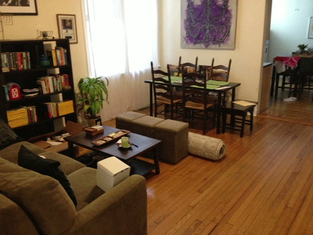 a living room and dining room with a wood floor