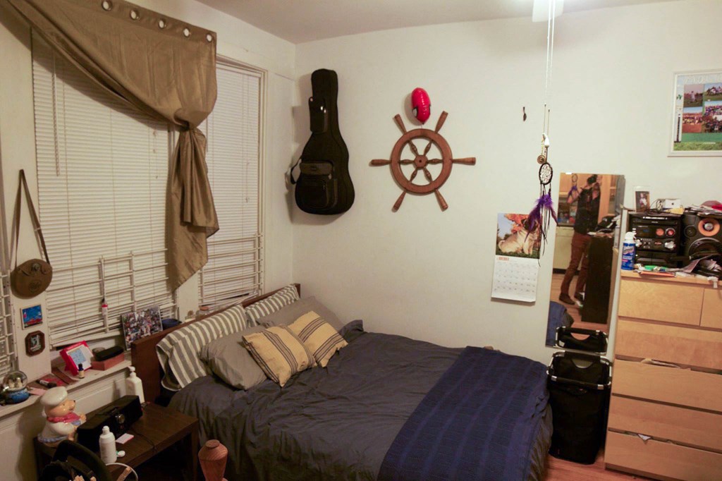 a bedroom with a bed and a steering wheel on the wall