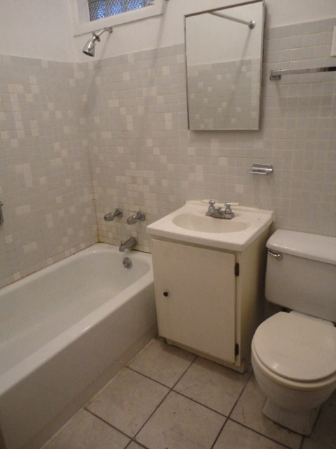 a bathroom with a sink toilet and a bath tub