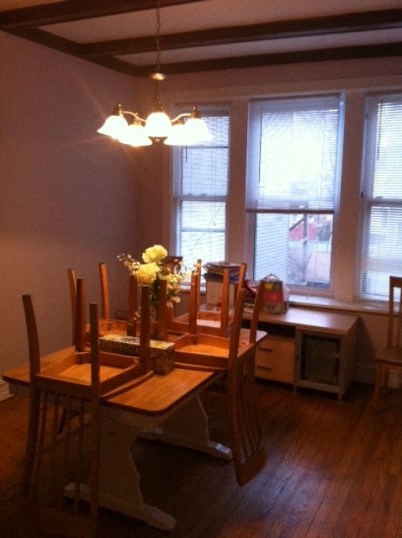 a dining room with a wooden table and chairs