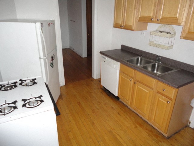 a kitchen with a stove and a sink and a refrigerator