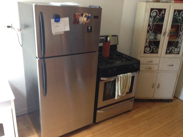 a stainless steel refrigerator and stove in a kitchen