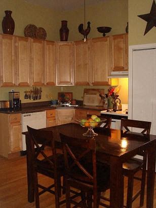 a kitchen with wooden cabinets and a wooden table