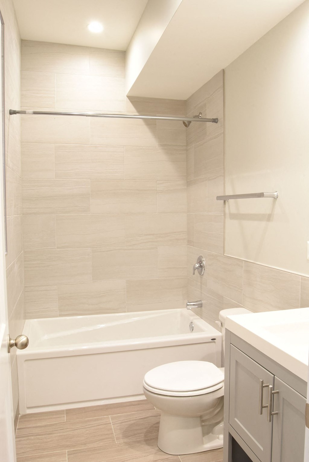 a bathroom with a shower and a toilet and a sink