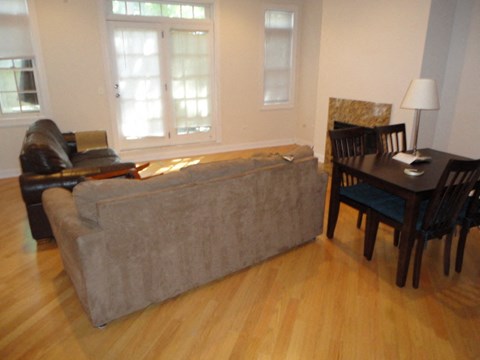 a living room with a couch and a dining room table