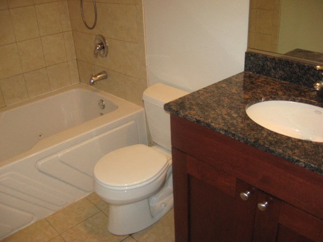 a bathroom with a toilet and a tub and a sink