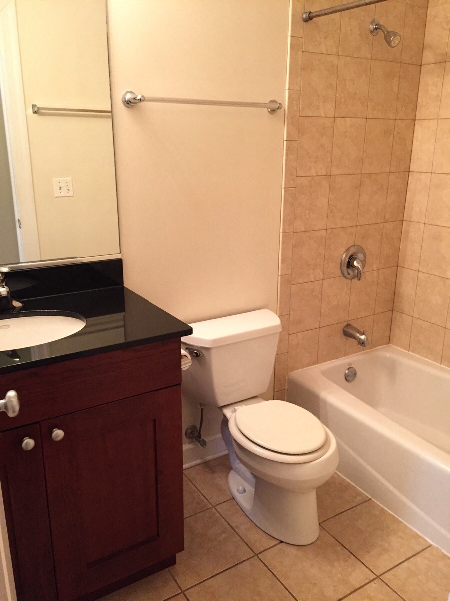 a bathroom with a toilet and a tub and a sink