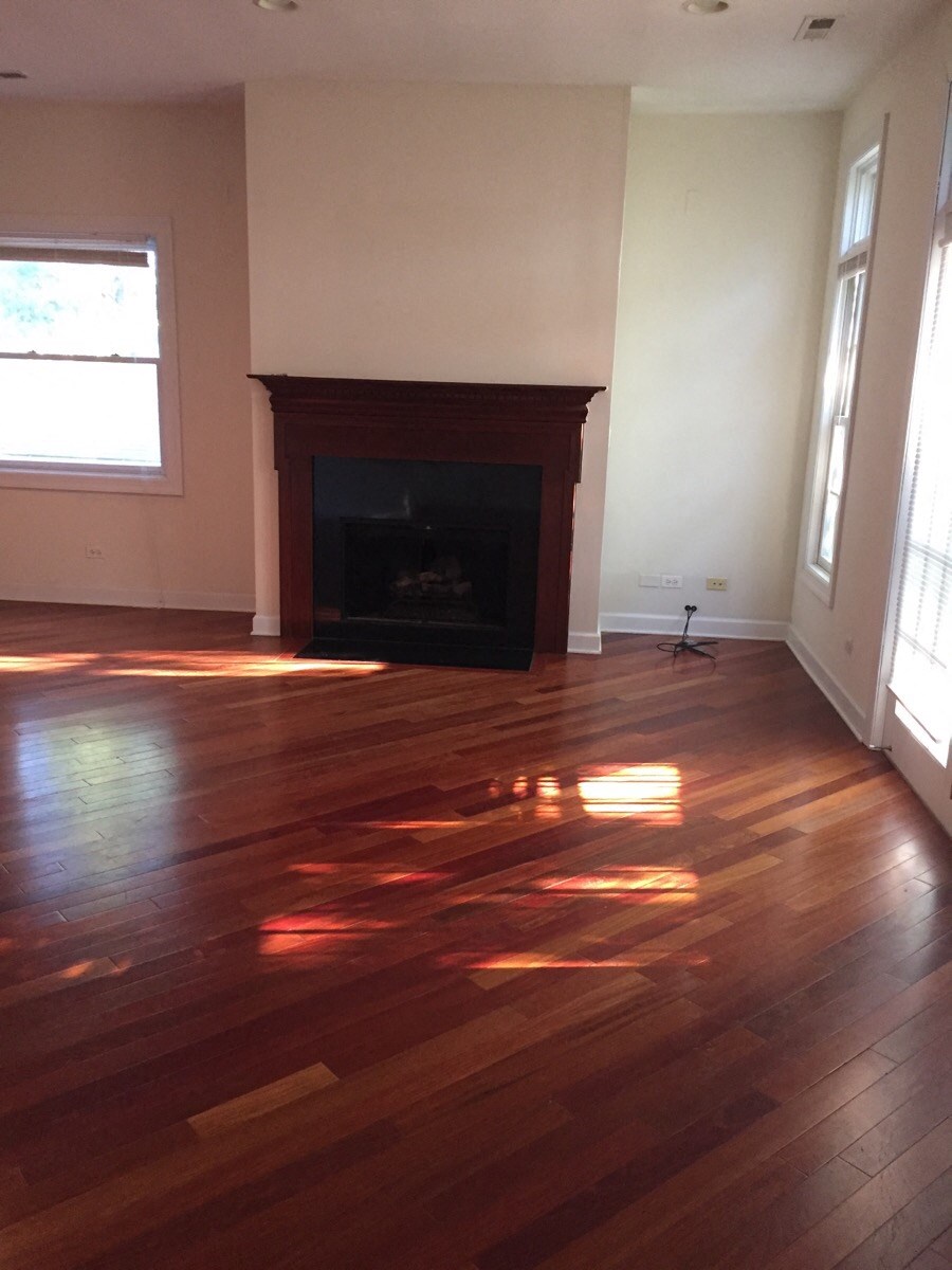the living room with hard wood floors and a fireplace