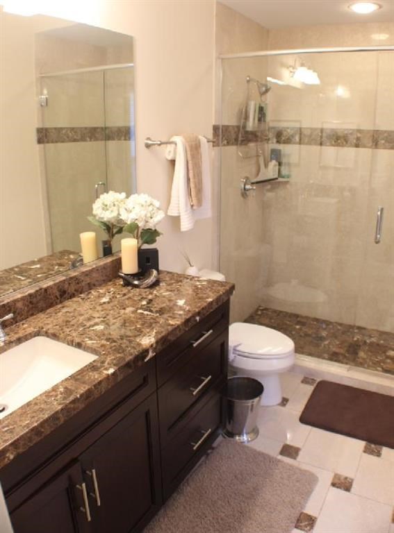 a bathroom with a toilet and a sink and a shower