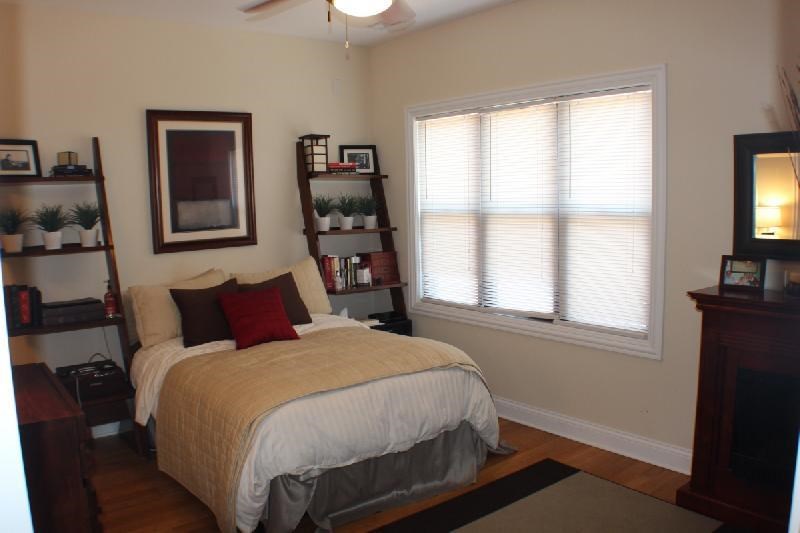 a bedroom with a bed and a window