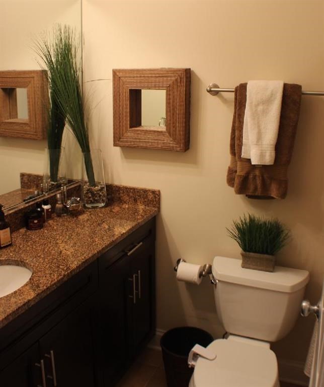 a bathroom with a toilet and a sink and a mirror