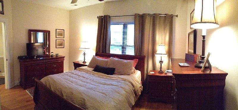 a bedroom with a bed and a dresser and a window