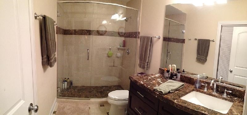 a bathroom with a shower and a sink and a toilet