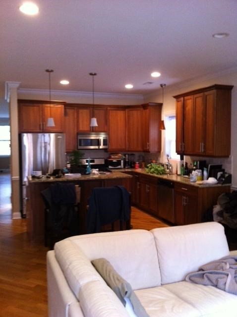 a kitchen and living room with a white couch