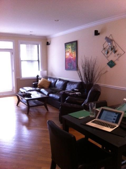 a living room with a couch and a table with a laptop