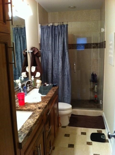 a bathroom with a toilet and a sink and a shower