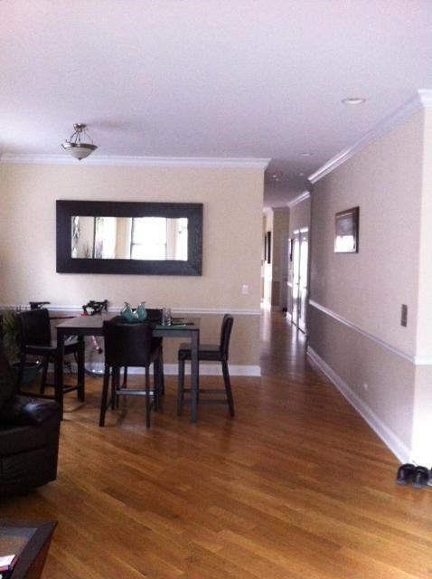 a living room and dining room with a table and chairs