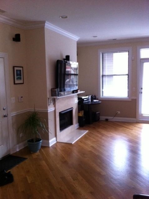an empty living room with a fireplace and a tv