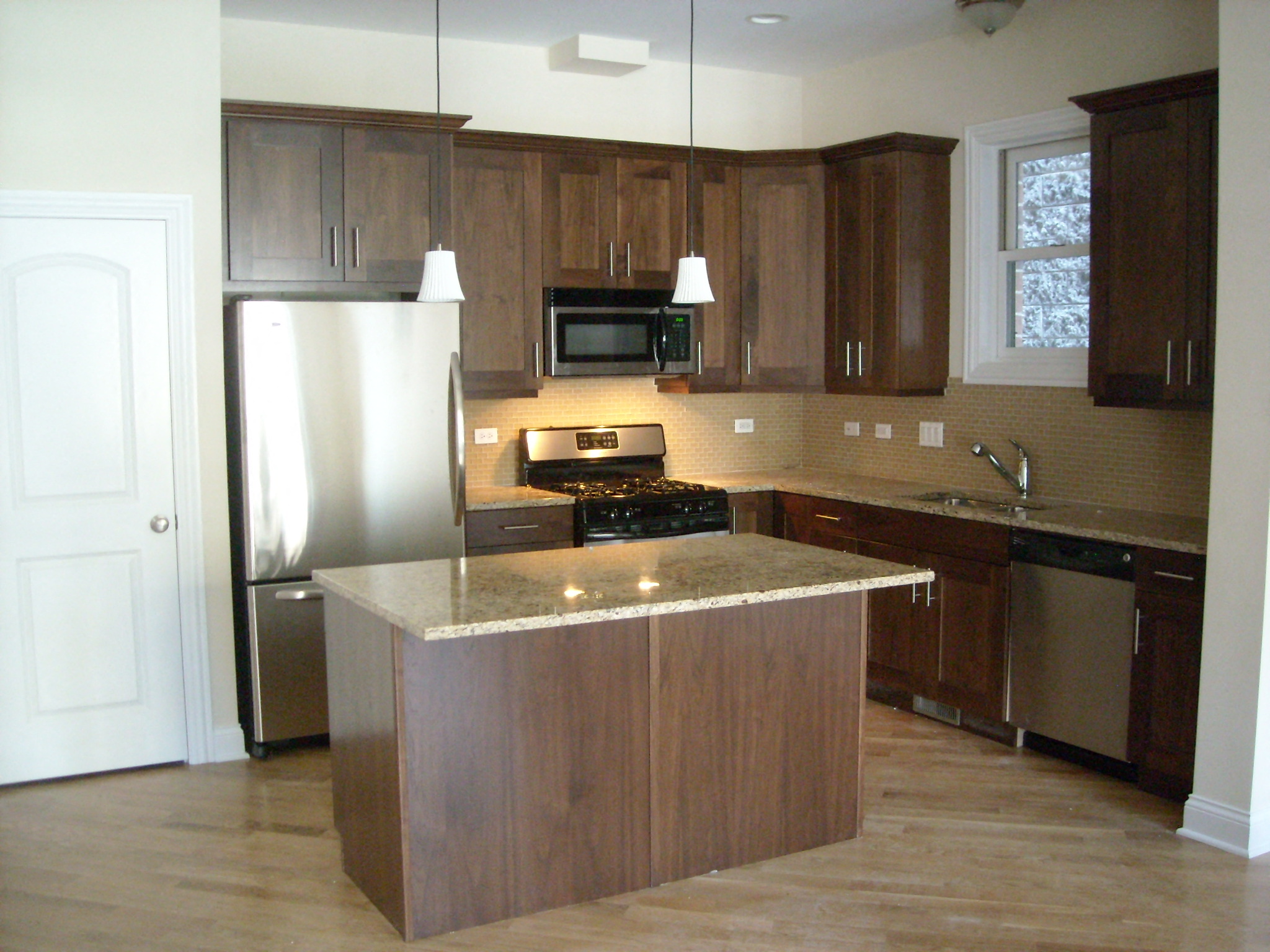 a kitchen with wooden cabinets and stainless steel appliances