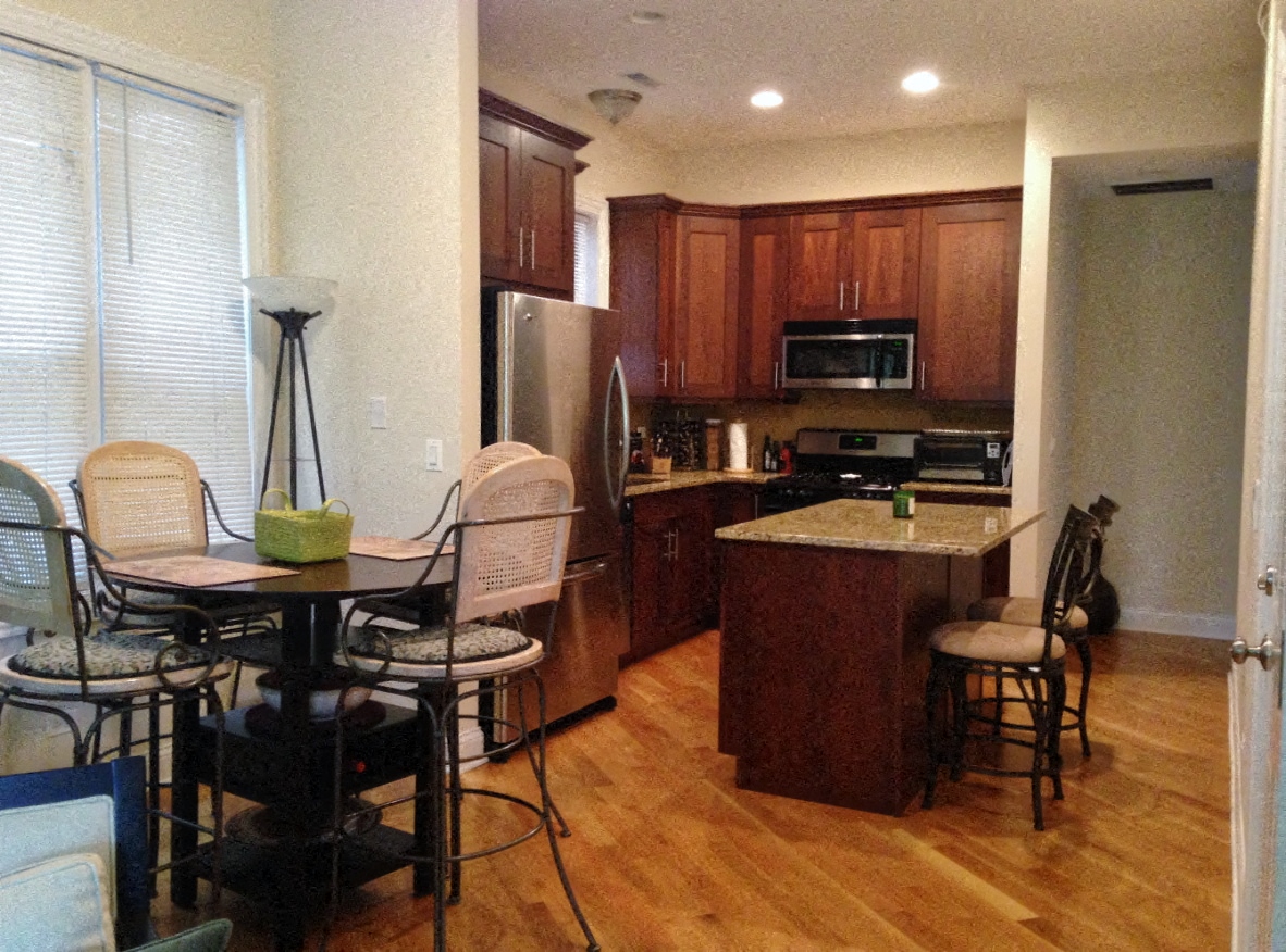 a kitchen and dining room with a table and chairs