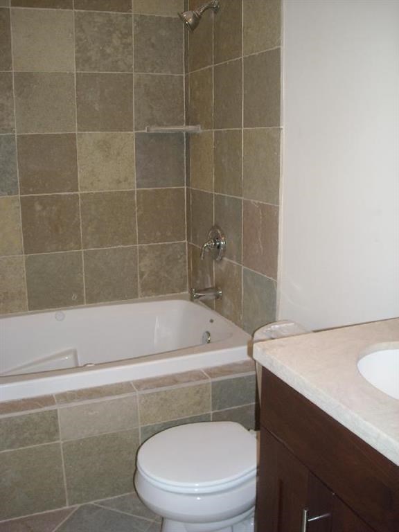 a bathroom with a toilet and a tub and a sink